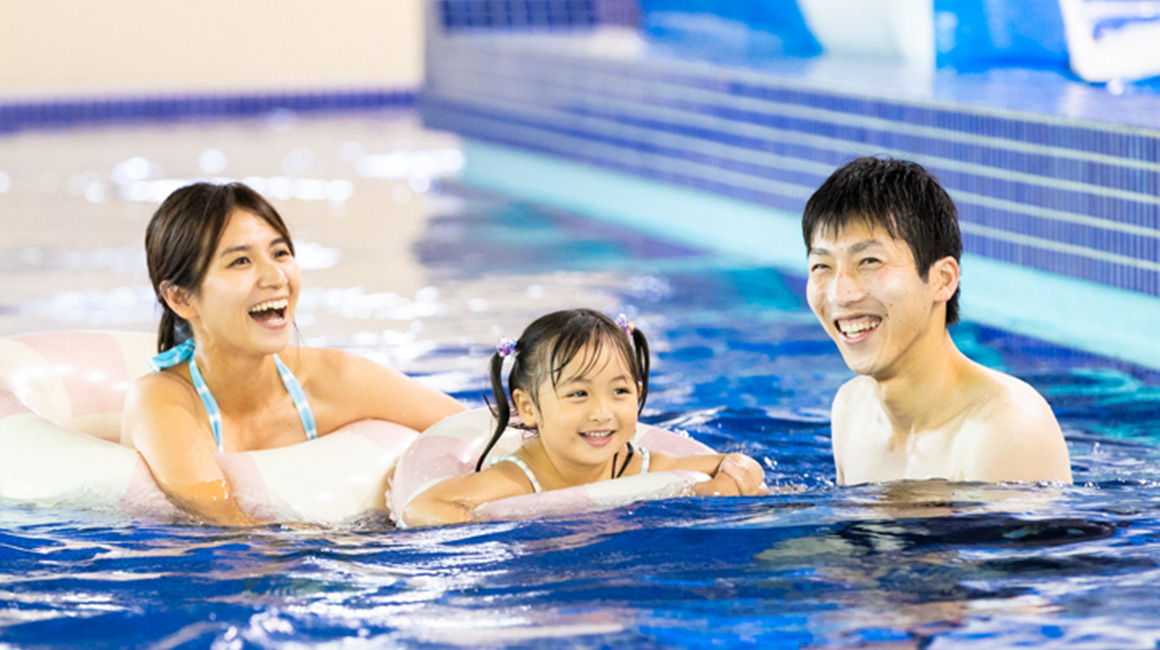 Image of a family playing in the pool